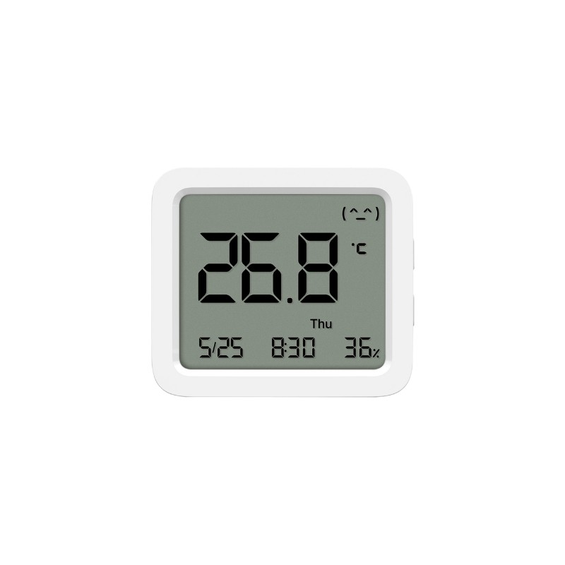 Xiaomi Mi Temperature and Humidity Monitor 3 prikazan na stolu sa LCD ekranom koji prikazuje temperaturu i vlažnost.